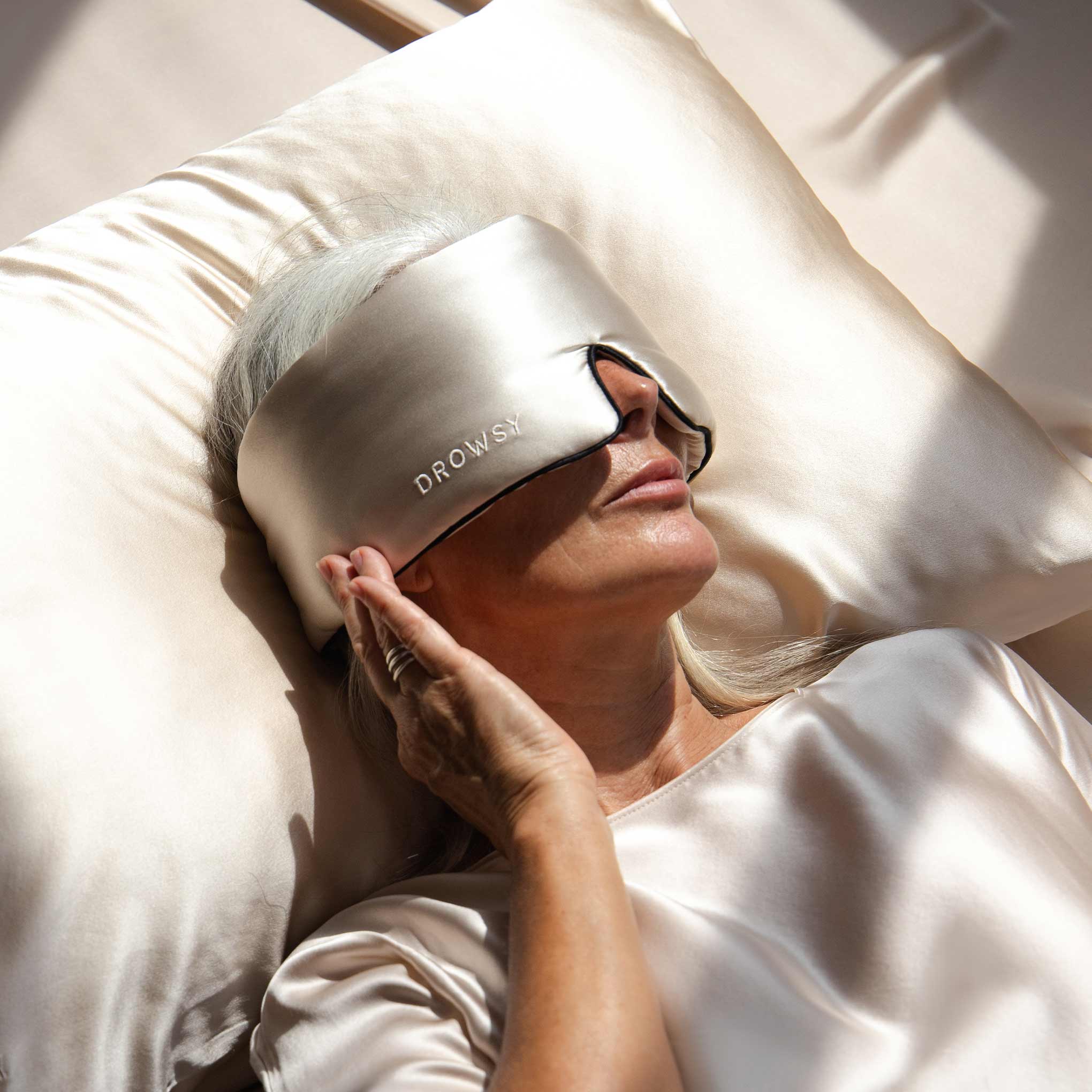 woman sleeping with white silk eye mask