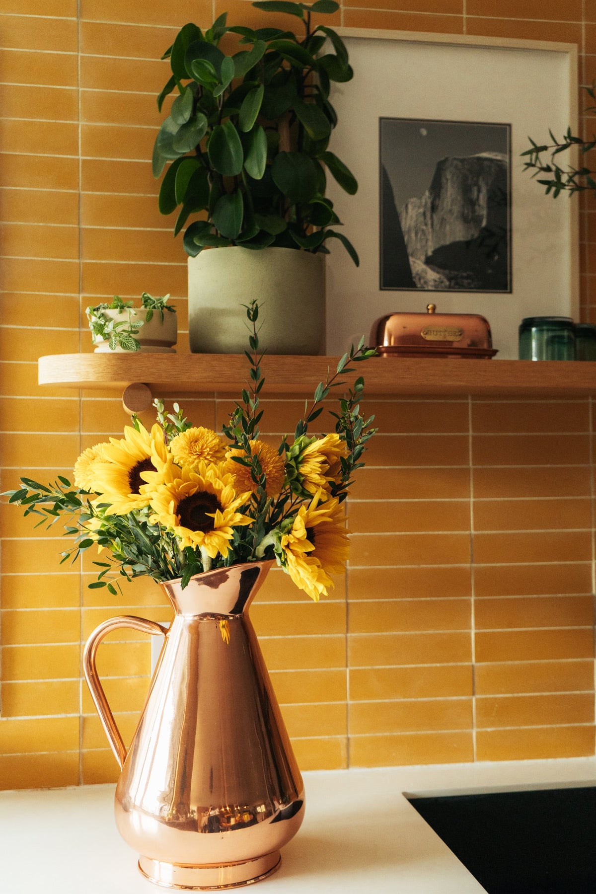 Galley & Fen copper heirloom vase with sunflowers by yellow tile