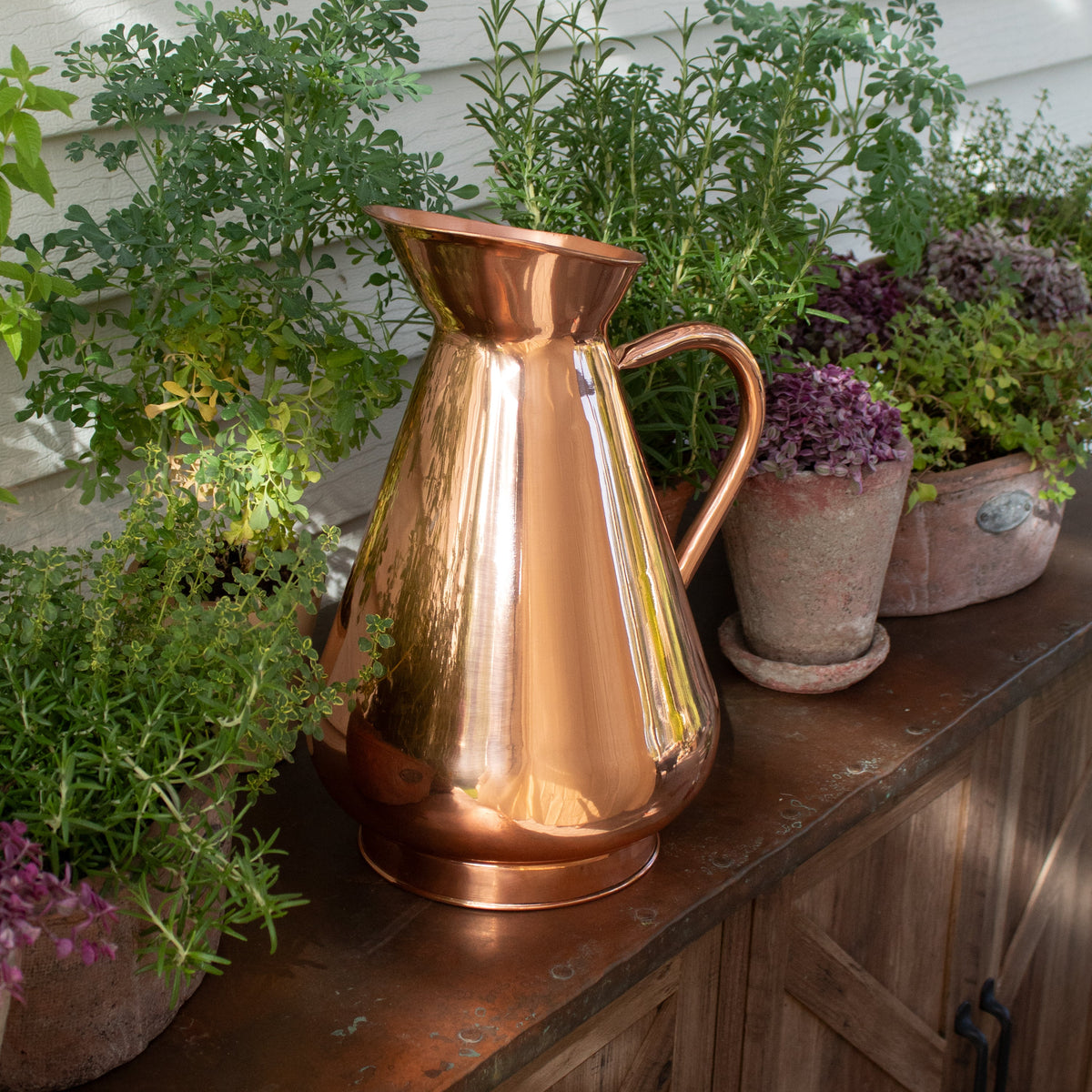 Galley & Fen copper heirloom vase among potted plants