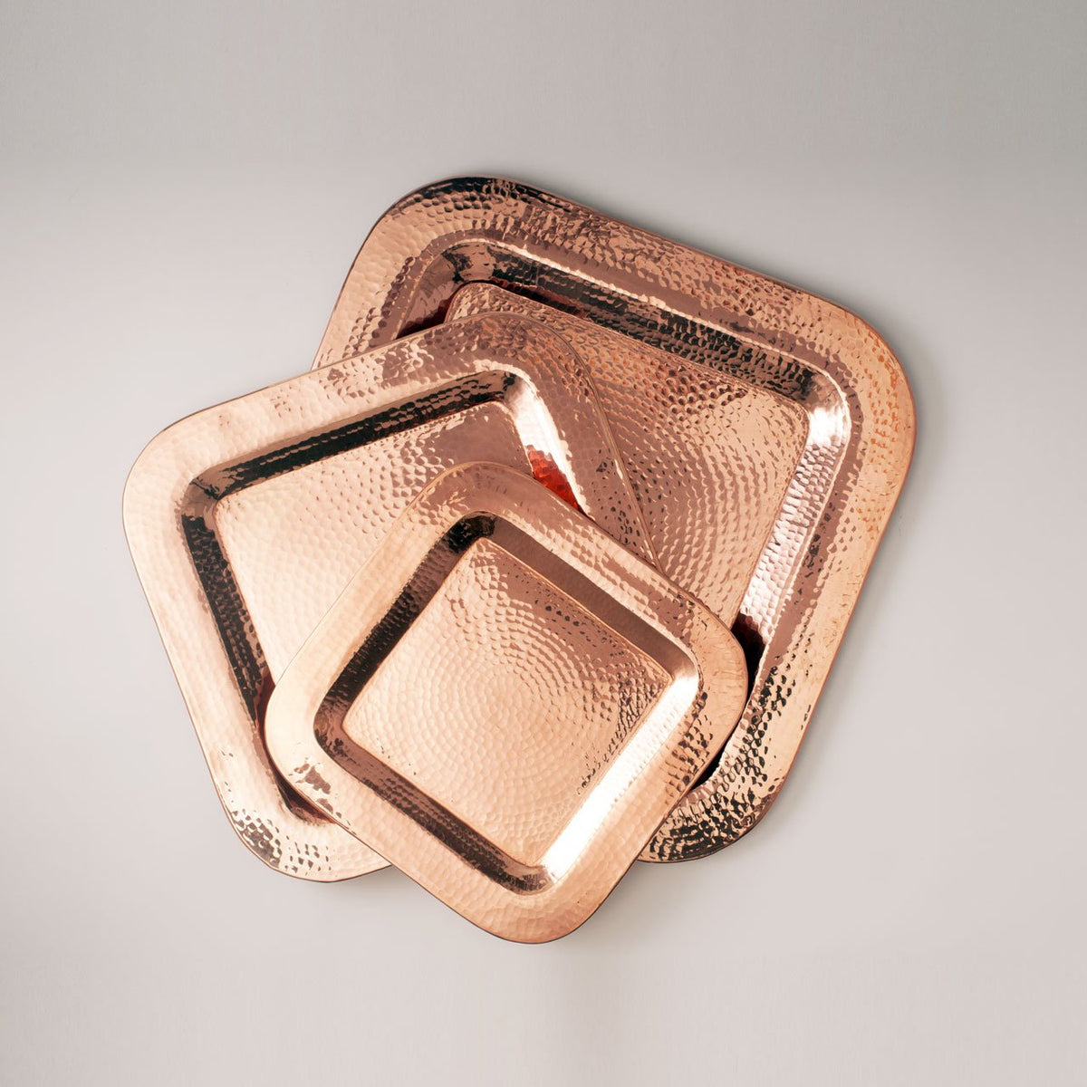 Sertodo Thessaly square copper platters in three sizes, stacked