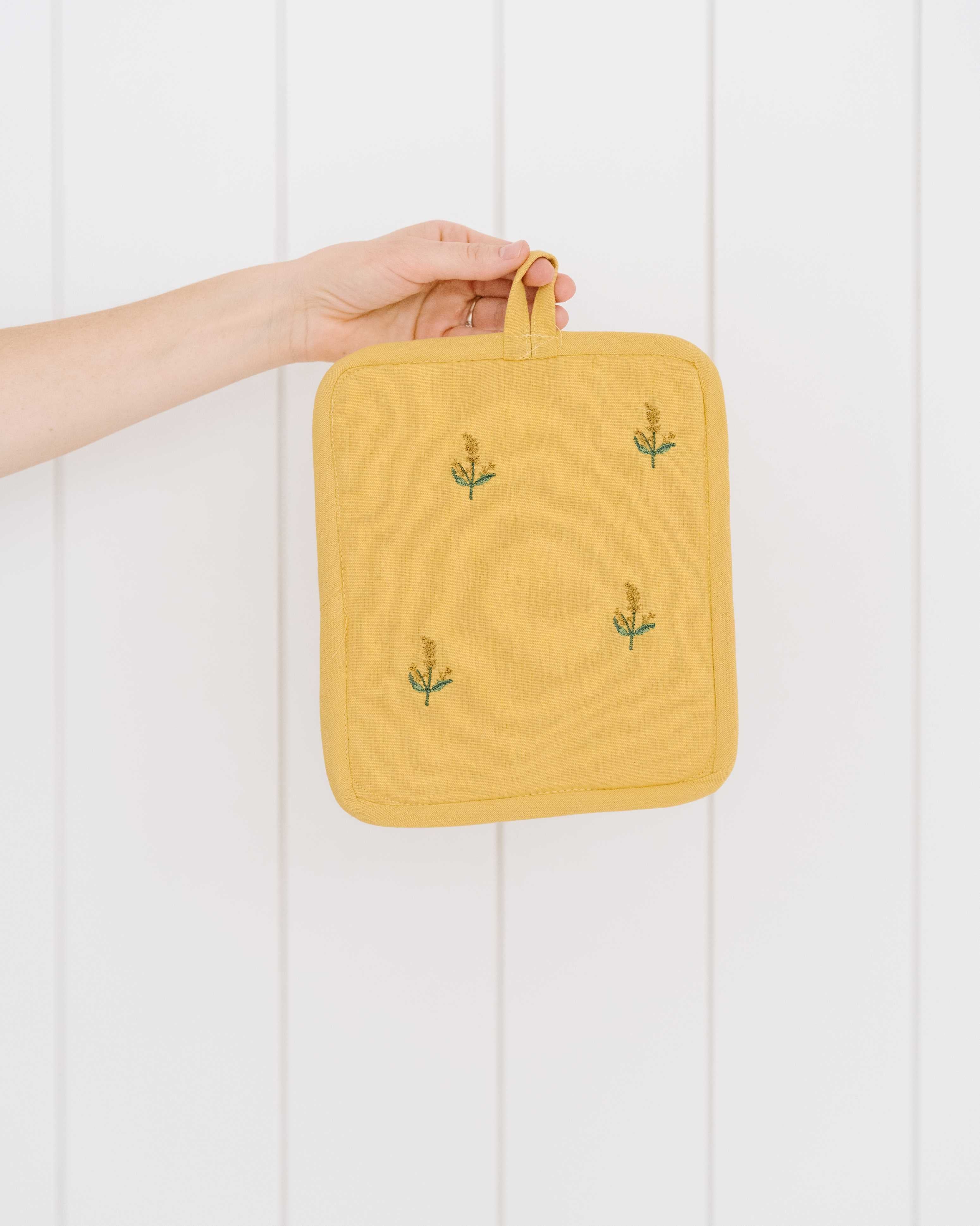 Gelber bestickter Topflappen