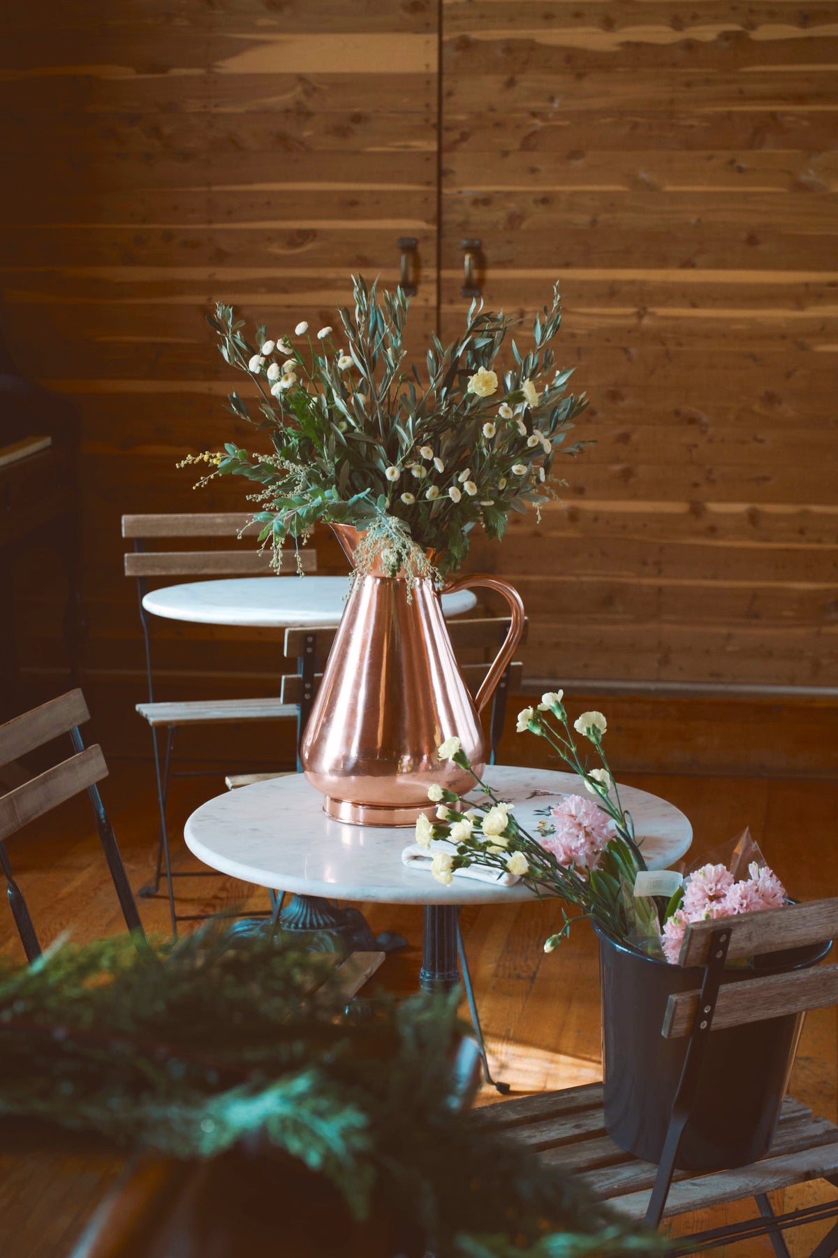 Galley & Fen copper heirloom vase on a cafe table