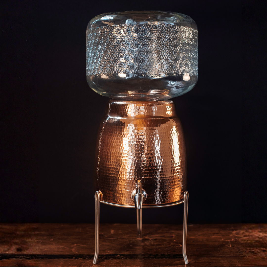 Sertodo Niagara copper water dispenser on a stand with a water jug on top