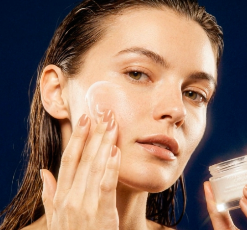 Woman applying Rosewater cream to her face with a dark background on mssincare.co