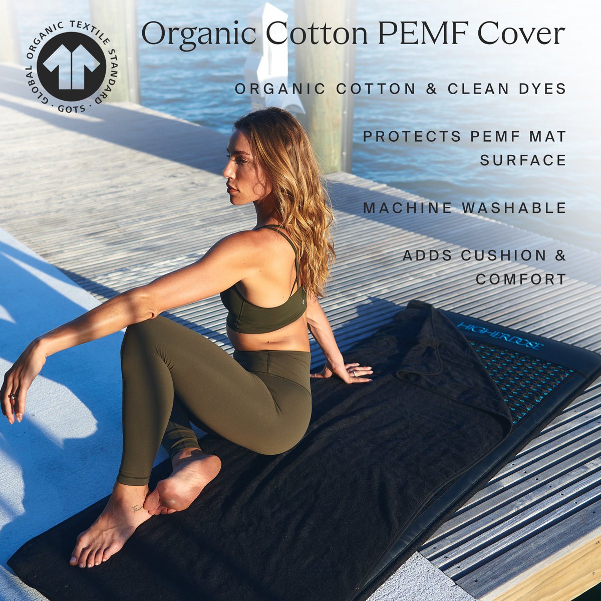 Woman sitting on a HigherDOSE PEMF mat with the organic cotton cover