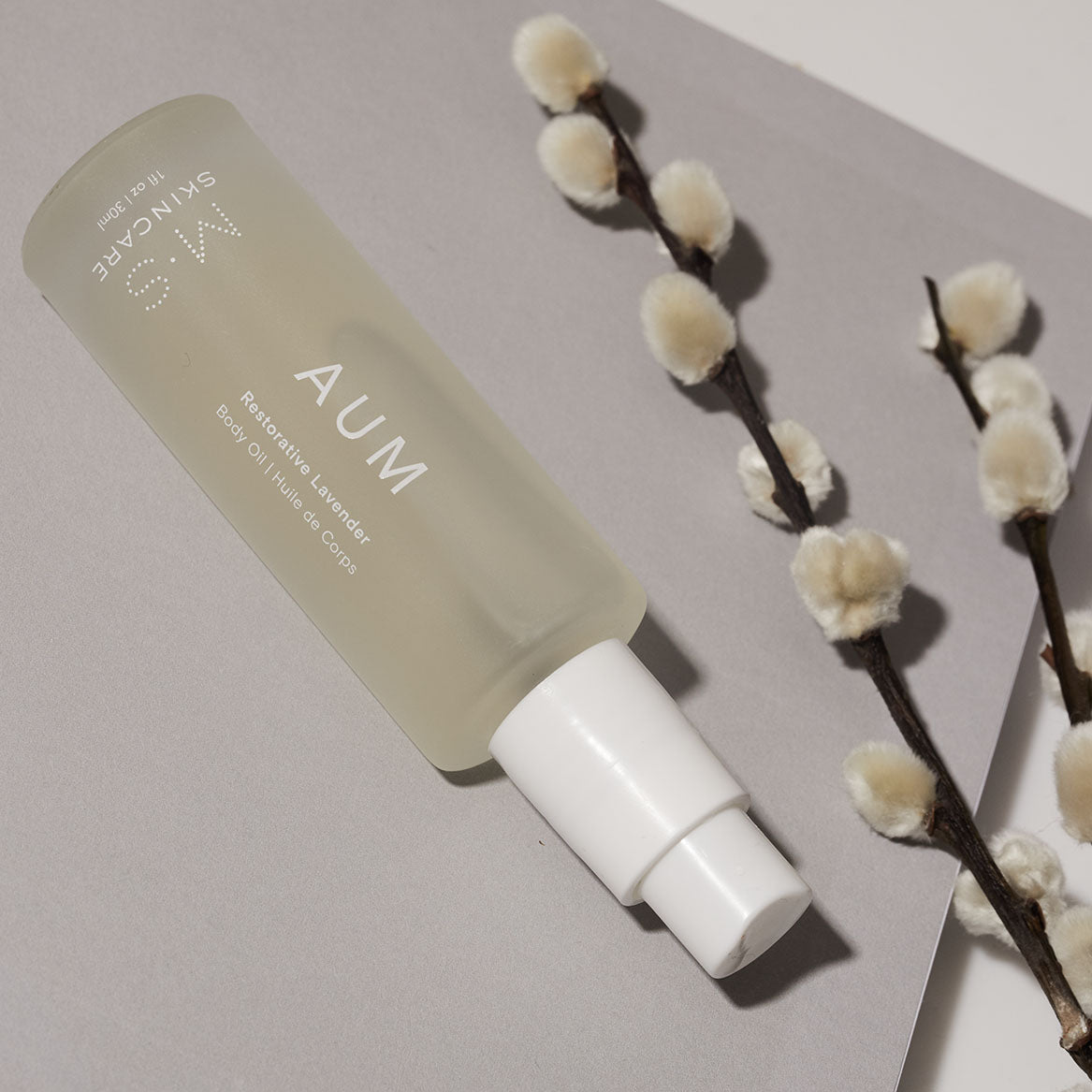 M.S Skincare AUM Lavender Restorative Body Oil -luxury oil in a frosted white bottle with white printing and pump with willow