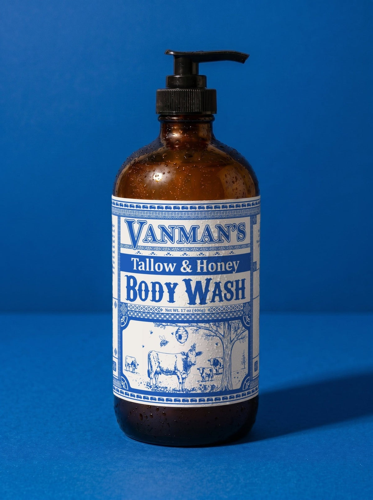 VanMan's Tallow & Honey Body Wash, 16 oz amber pump bottle on a blue background