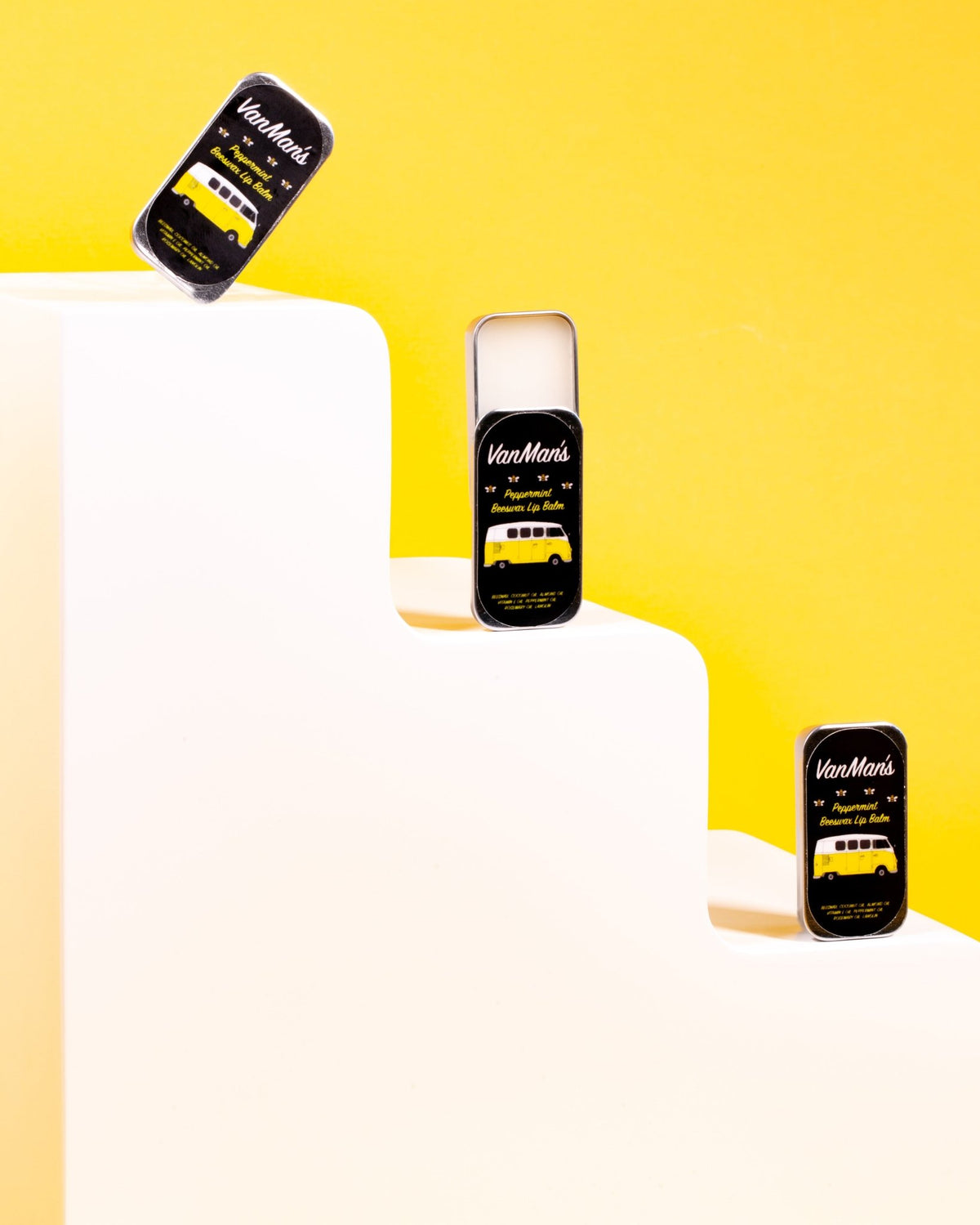 VanMan's Peppermint Beeswax Lip Balm tins on white steps