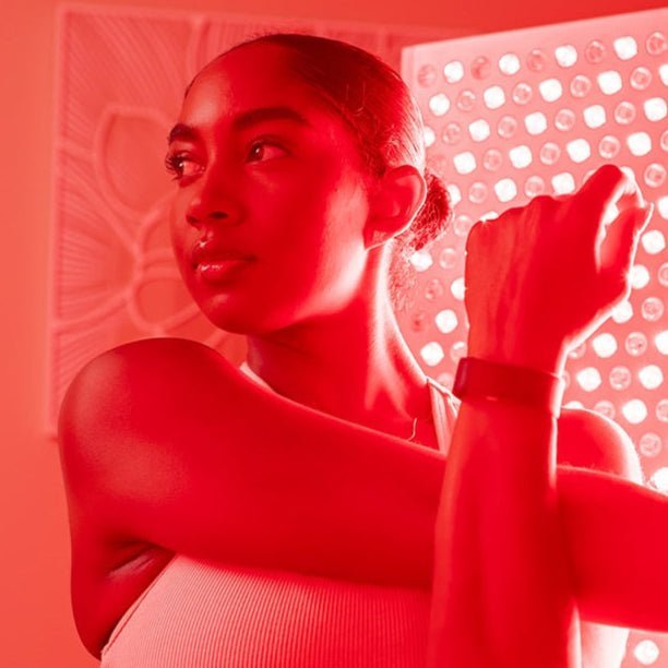 young woman using red light therapy
