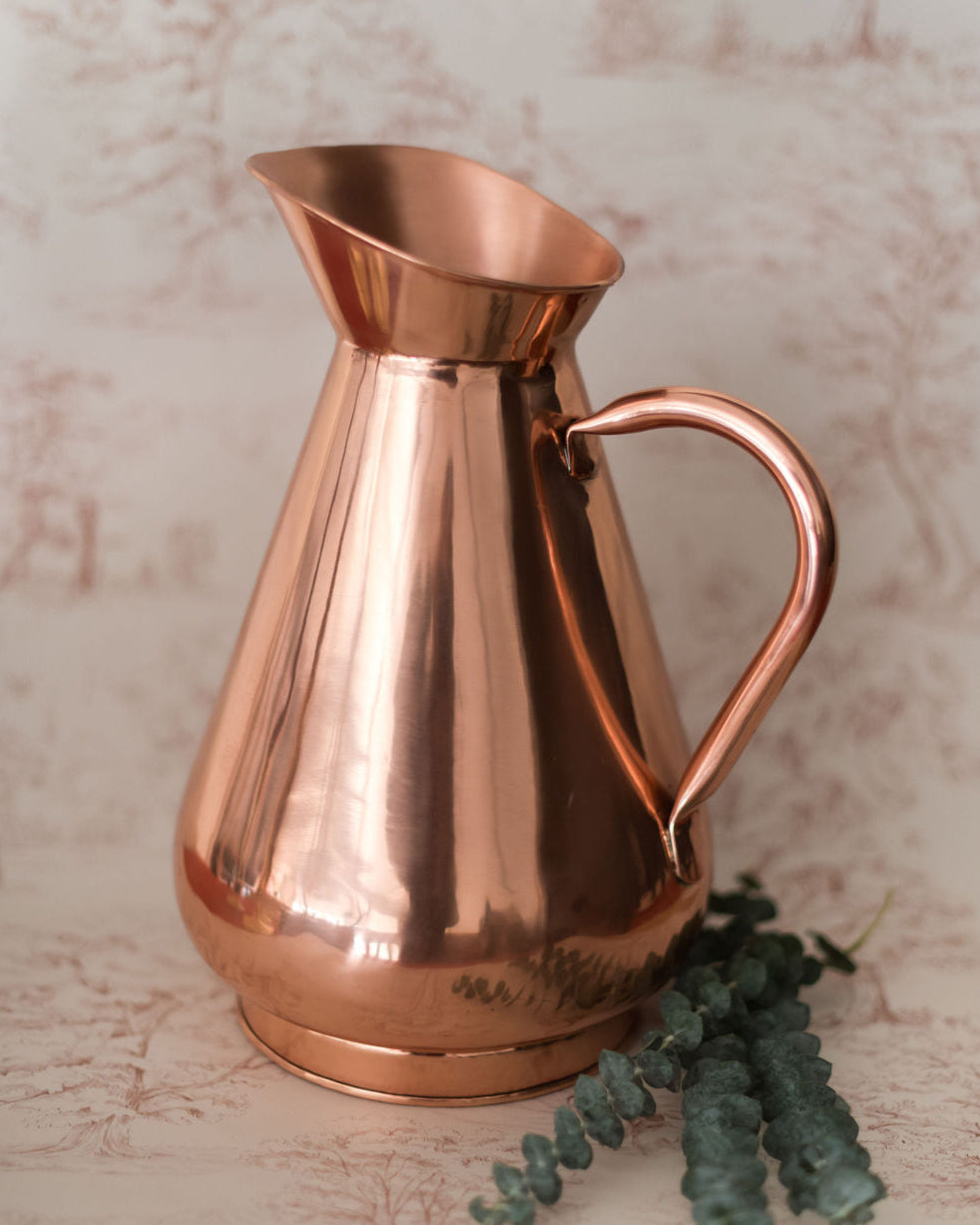 Galley & Fen copper heirloom vase with eucalyptus on toile fabric
