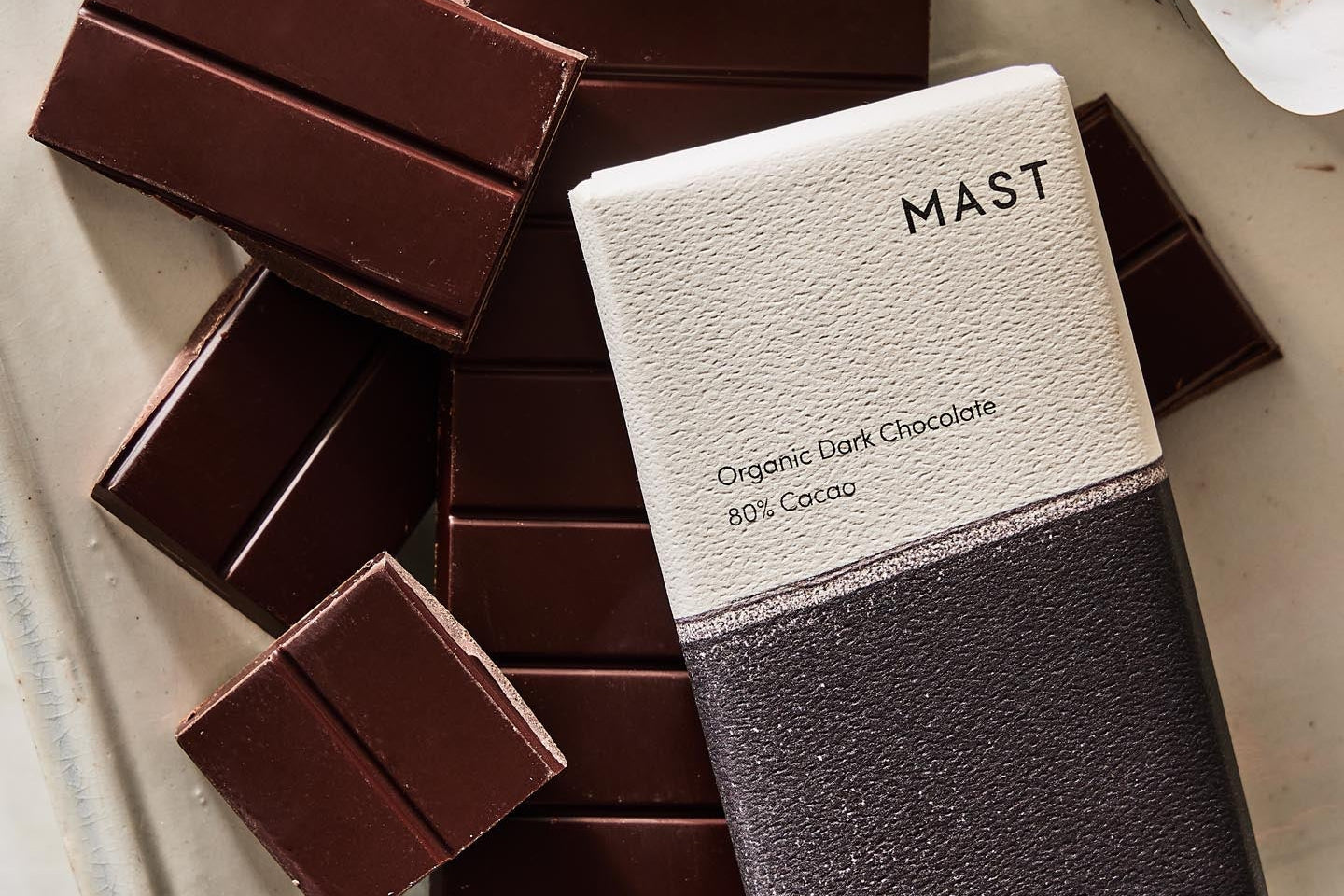 Mast Organic Dark Chocolate bar on a white surface with other chocolate bars.