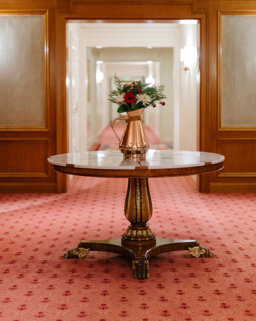 Galley & Fen copper heirloom vase on a round table in a hallway