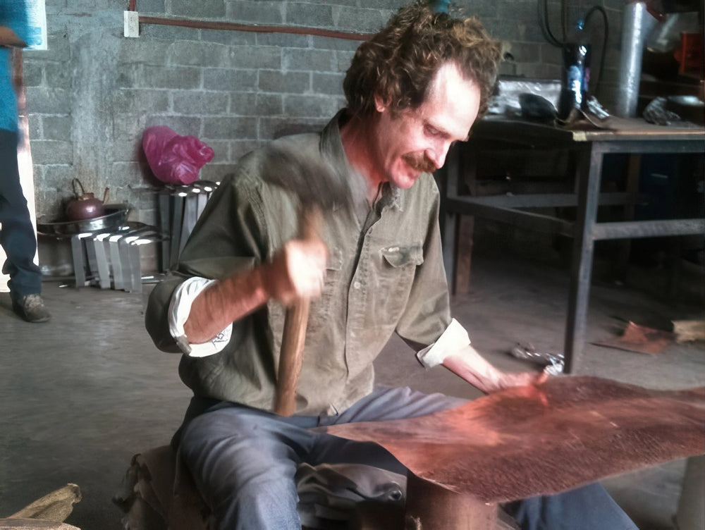 Sertodo coppersmith hand hammering a sheet of pure copper in the workshop