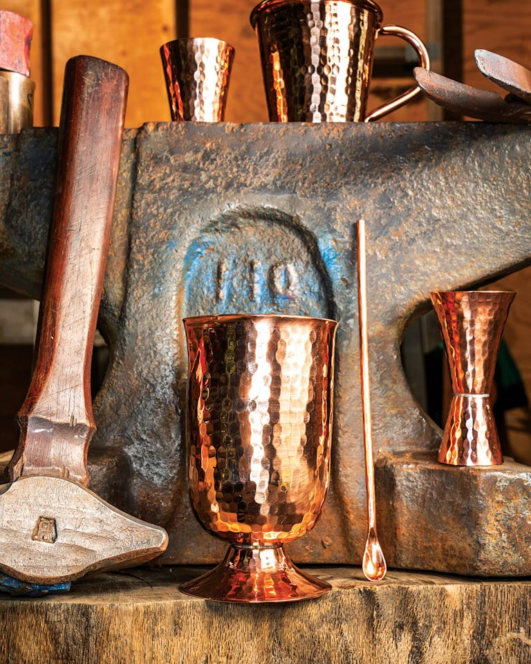 Hand-hammered Sertodo copper cups on an anvil