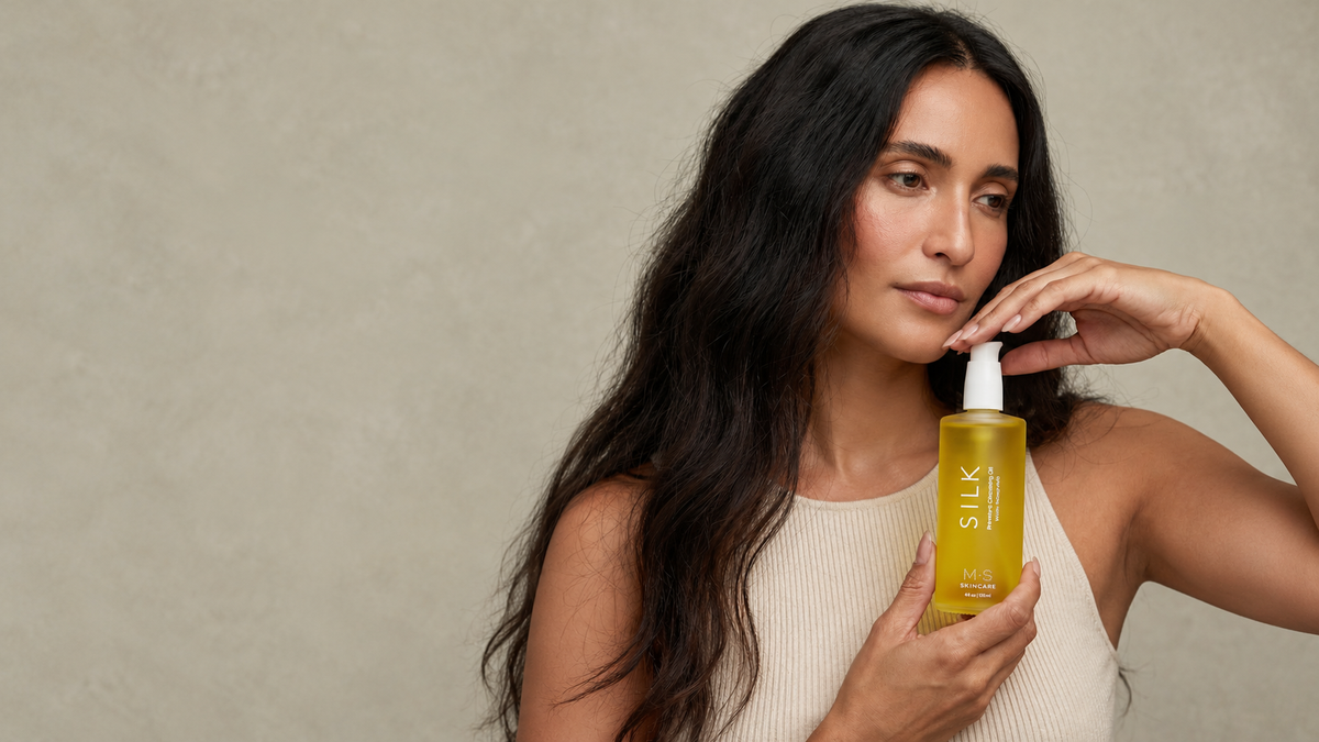 Woman holding Silk Cleansing Oil by M.S Skincare