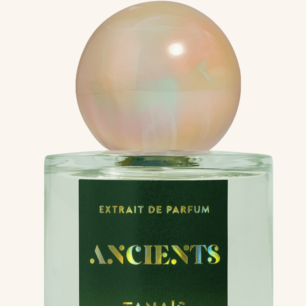 Perfume bottle with a colorful cap on a white background