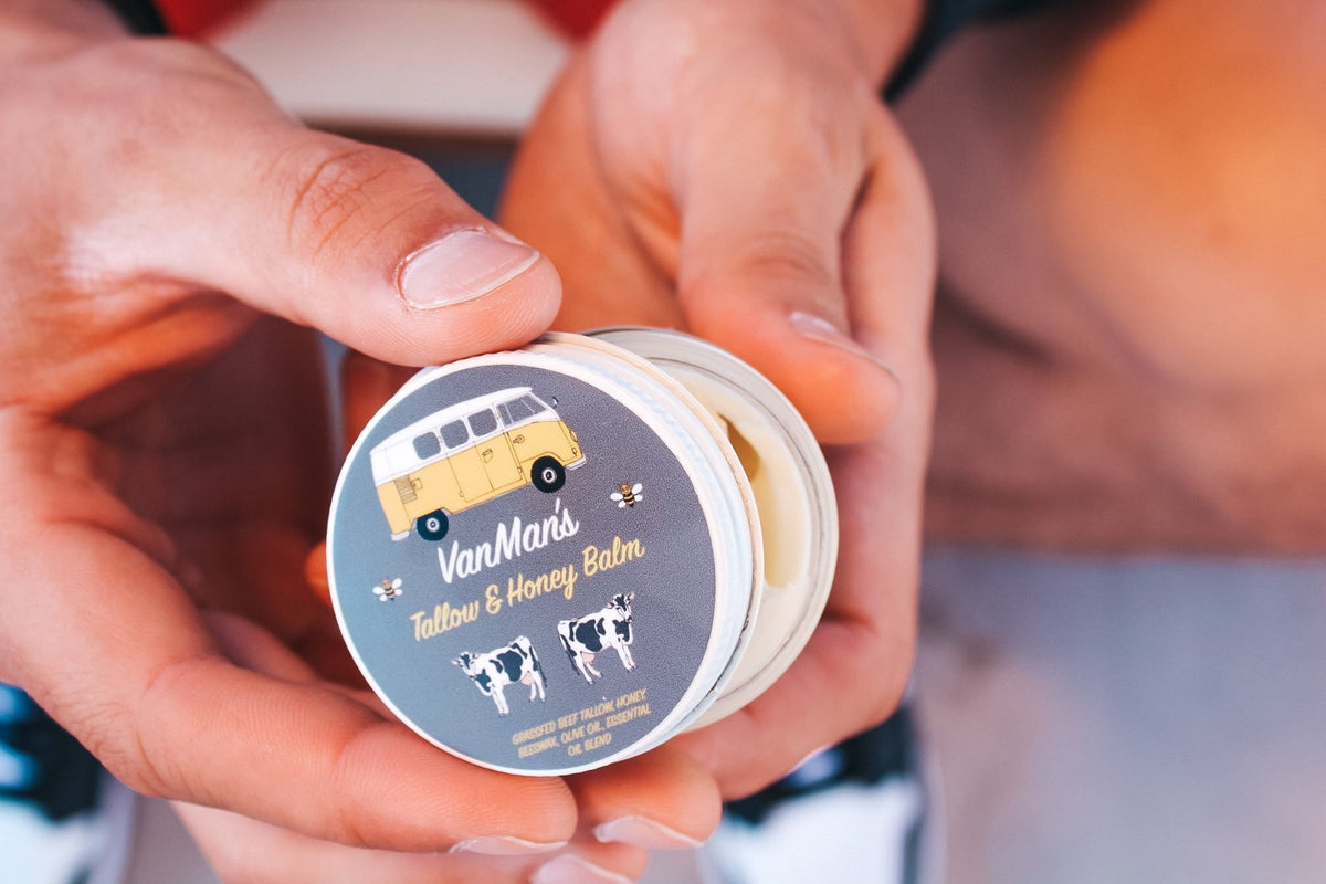 Hands holding an open jar of VanMan's Tallow & Honey Face Balm